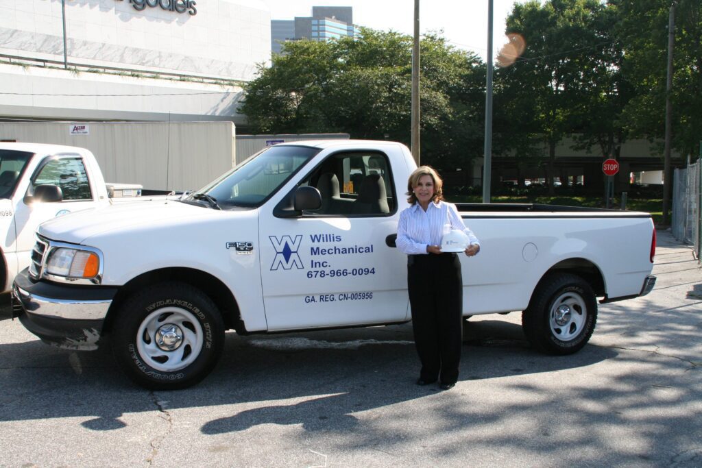 Leticia Willis Next to Willis Mechanical service truck
